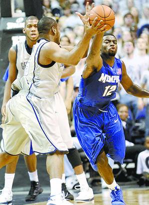 Georgetown's Austin Freeman, left, battles for a loose ball against Memphis' Tyreke Evans (12) during the first half of an NCAA college men's basketball game, Saturday, Dec. 13, 2008, in Washington.(AP Photo/Nick Wass)